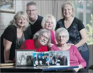  ?? — POSTMEDIA NEWS ?? The family of Bessie Sedor, 91, gather around her. Among her family photos is one of her long lost daughter, Carole Knight, right.