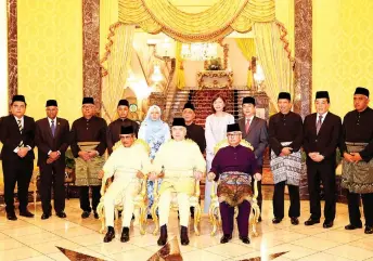  ?? — Bernama photo ?? Sultan Nazrin (seated, centre) with the new state exco, headed by Menteri Besar Datuk Seri Saarani Mohamad (standing, centre). Flanking the Sultan are Raja Muda Perak Raja Jaafar Raja Muda Musa (le ) and Raja Dihilir Perak Raja Iskandar Dzulkarnai­n Sultan Idris Shah.