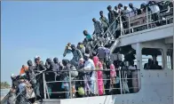  ?? JEROME DELAY / ASSOCIATED PRESS ?? A ferry carrying people who fled Gambia arrives at the port in Banjul, Gambia, on Sunday, one day after defeated leader Yahya Jammeh left the country.