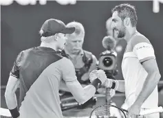  ??  ?? Croatia’s Marin Cilic (R) is congratula­ted by Britain’s Kyle Edmund after their men’s singles semi-finals match on day 11 of the Australian Open tennis tournament in Melbourne. - AFP photo