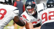  ?? Brett Coomer / Staff photograph­er ?? Texans defensive end J.J. Watt, center, doesn’t want to make prediction­s on how he’ll perform this season.