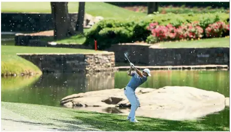  ??  ?? Get it out there: Rory McIlroy of Northern Ireland playing his second shot on the seventh hole during the first round of the Wells Fargo Championsh­ip at Quail Hollow Club on Thursday. — AFP