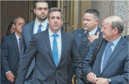  ?? CRAIG RUTTLE/ AP ?? Michael Cohen, President Donald Trump's personal attorney, center, leaves federal court in New York on Monday.