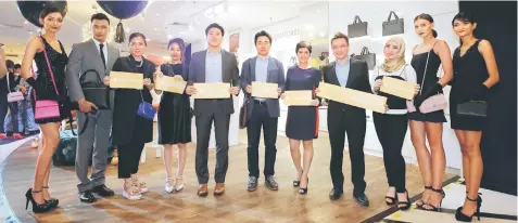  ??  ?? (From third left) Noh, Shin, Chris, Jeong Hyun, Legendre, Yeap and Diana pose for a photo together with models showcasing Louis Quatorze products.