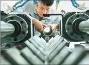  ?? CHEN XIAODONG / FOR CHINA DAILY ?? A worker processes components for a power generation unit in Xuanhua, Hebei province.