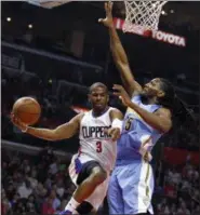  ?? ALEX GALLARDO — ASSOCIATED PRESS ?? Los Angeles Clippers guard Chris Paul, left, goes up under the basket, next to Denver Nuggets forward Kenneth Faried during a 2016 game in Los Angeles.