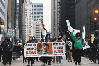  ?? Shafkat Anowar / Associated Press ?? Protesters march along Chicago’s South Michigan Avenue ahead of the video release of the police shooting of 13yearold Adam Toledo, which police described as an armed confrontat­ion.