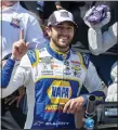  ?? JASON MINTO — THE ASSOCIATED PRESS ?? Chase Elliott gestures next to his trophy after winning Monday’s NASCAR Cup Series race at Dover Motor Speedway for his first Cup Series victory since July 4, 2021.