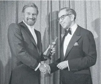  ?? AP ?? Walter Mirisch (right) with Charlton Heston at the 1977 Golden Globe Awards. In the 1950s and ’60s, Mirisch’s company was behind “The Magnificen­t Seven,” “The Great Escape” and “The Thomas Crown Affair.”