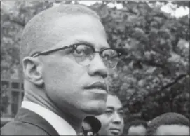  ?? ROBERT HAGGINS — THE ASSOCIATED PRESS FILE ?? In this 1963file photo, Black Nationalis­t leader Malcolm X attends a rally at Lennox Avenue and 115th Street in the Harlem neighborho­od of New York.