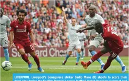  ??  ?? LIVERPOOL: Liverpool’s Senegalese striker Sadio Mane (R) shoots to score their third goal during the English Premier League football match between Liverpool and West Ham United at Anfield in Liverpool, north west England yesterday. — AFP