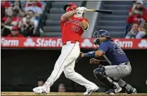  ?? ALEX GALLARDO/AP ?? Angels slugger Mike Trout follows through on a two-run homer Tuesday. Through the first two weeks of the season, the major league batting average was .242, while the average game time was 2:39.
