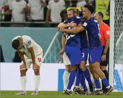  ?? RICARDO MAZALAN — THE ASSOCIATED PRESS ?? U.S players celebrate after their victory over Iran on Tuesday in a World Cup Group B match that sent the Americans to the knockout stage.