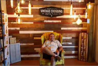  ?? KEITH REYNOLDS — THE MORNING JOURNAL ?? Owner Tim Olney poses Aug. 15 at his store, Vintage Crossing, during an open house for the new location at 2813 Liberty Ave. in Vermilion.