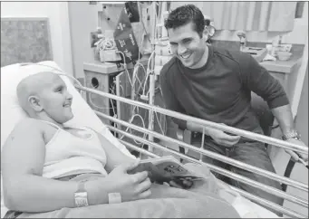  ?? JOHN MAHONEY/ THE GAZETTE ?? Canadiens captain Brian Gionta laughs with Jonathan Caiola, 12, during a visit by players to the Montreal Children’s Hospital. Jonathan recently had a tumour removed from his femur.