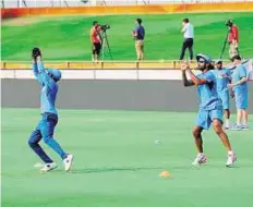  ?? PTI ?? Catch ‘em Ravindra Jadeja (front) takes a catch as Shikhar Dhawan looks on during a training session in Perth yesterday.