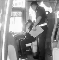  ??  ?? JPJ personnel carrying out checks inside an express bus.