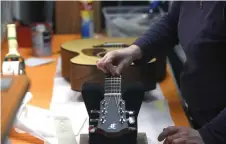  ?? — AFP photo ?? An employee of the Furch family company works on a guitar on March 11 in the Furch manufactor­y in Velke Nemcice, Czech Republic.