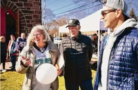  ?? Brian A. Pounds/Hearst Connecticu­t Media ?? From left, Souper Bowl tailgating party organizer Rachel Merva, of Milford, laughs with former NFL football players Terry Hanratty, of the Pittsburgh Steelers, and Niko Koutouvide­s, of the New England Patriots, at the fundraiser on Saturday for the Beth-El Center and Milford Food Bank at Mary Taylor Memorial United Methodist Church in Milford.