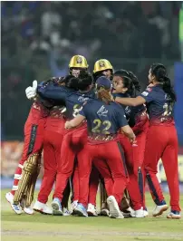  ?? — PTI ?? Jubilant RCB players on the field.