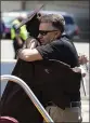  ?? MICHAEL CONROY — THE ASSOCIATED PRESS ?? Ted Foxworthy, right, hugs his son Jacob Foxworthy as they walked off the track where he received his Speedway High School diploma during a ceremony at the Indianapol­is Motor Speedway in Indianapol­is on May 30.