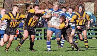  ?? ?? PLOUGHING THROUGH: Rugby league action from 2002 with East Hull (blue and white) playing against Skirlaugh (yellow and black). Here
East Hull’s James Aramayo was photograph­ed in action for Easts.