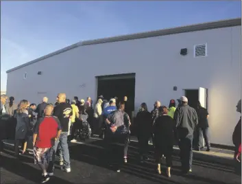  ?? FILE PHOTO BY MARA KNAUB/YUMA SUN ?? PEOPLE STREAM INTO THE CROSSROADS MISSION’S new food and storage warehouse after a grand opening ribbon-cutting ceremony on March 22.