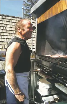  ?? SUBMITTED PHOTO ?? Jean Mayer tending the grill at his famous Hotel St. Bernard deck, overlookin­g Al’s Run on the front side of Taos Ski Valley.