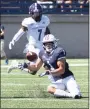  ?? Steve Musco / Submitted photo ?? Yale’s Mason Tipton goes down low to catch a pass in front of Holy Cross defender John Smith during Saturday’s game.