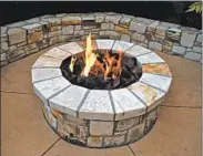  ?? DREAMSTIME ?? A fire feature creates a cozy ambience and invites family and friends to gather in an outdoor entertaini­ng space.