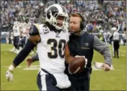  ?? MARK ZALESKI — THE ASSOCIATED PRESS ?? Los Angeles Rams running back Todd Gurley (30) is congratula­ted by head coach Sean McVay after Gurley scored a touchdown against the Tennessee Titans on an 80-yard pass reception in the first half of an NFL football game Sunday in Nashville, Tenn.