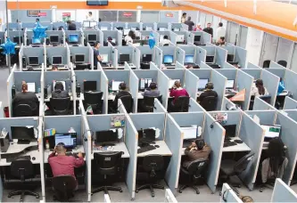  ?? ALEX COSSIO/AP ?? Workers sit at desks at Firstkonta­ct Center, a call centre in the northern border city of Tijuana, Mexico.