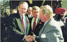  ?? PHOTO SUPPLIED TO METROLAND ?? Gene McKeiver shakes hands with former Prime Minister Jean Chrétien during a visit to MP Peter Adams' (seen in back) city home in 1998.