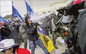  ?? Kent Nishimura Los Angeles Times ?? TRUMP BACKERS clash with police on Jan. 6. Washington’s acting police chief testified that military brass seemed to fret about the optics of troops on the Capitol grounds when police asked for National Guard backup.