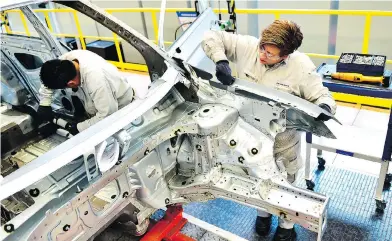  ?? PEDRO PARDO / AFP / GETTY IMAGES FILES ?? Employees on the assembly line of the Tiguan at the Volkswagen car plant in Puebla, central Mexico. Rules under a proposed new NAFTA deal require 75 per cent of a vehicle be made in the U.S. or Mexico, up from 62.5 per cent.