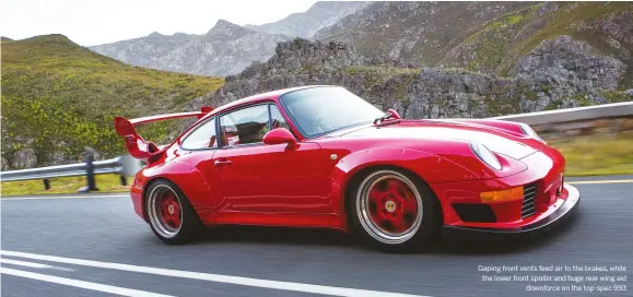  ??  ?? Gaping front vents feed air to the brakes, while the lower front spoiler and huge rear wing aid downforce on the top-spec 993