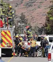  ?? Brendan Kergin / Associated Press ?? First responders transport an injured person at the scene of a crash involving a Canadian Forces Snowbirds aircraft in Kamloops, British Columbia.