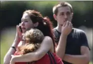  ?? ANDREW NELLES — THE TENNESSEAN ?? Kaitlyn Adams, a member of the Burnette Chapel Church of Christ, hugs another church member at the scene after shots were fired at the church on Sunday in Antioch, Tenn.