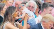  ?? REUTERS ?? Melania Trump holds a baby at a White House event.