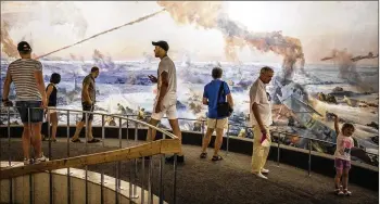  ?? SERGEY PONOMAREV / THE NEW YORK TIMES ?? Tourists visit a panoramic mural, “The Defeat of the Fascist Armies at Stalingrad,” at the Mamayev Kurgan memorial complex in Volgograd, Russia, in August.