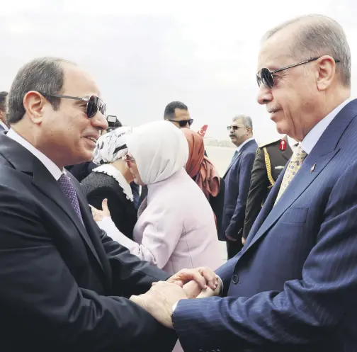  ?? (AA Photo) ?? President Recep Tayyip Erdoğan (R) is welcomed by Egyptian President Abdel-Fattah el-Sissi as he arrives at Cairo Internatio­nal Airport for his official visit to Egypt, Feb. 14, 2024.