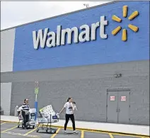  ?? ALAN DIAZ / ASSOCIATED PRESS ?? Shoppers leave a Walmart store in Hialeah Gardens, Fla., in June. Same-store sales in the third quarter for the retail giant rose 2.7 percent, the biggest gain in eight years.