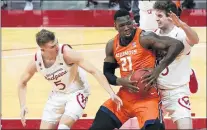  ?? MORRY GASH / AP ?? Illinois Kofi Cockburn (21) tries to get past Wisconsin’s Tyler Wahl (5) and Nate Reuvers during the first half Saturday .Cockburn led the Illini with 19 points in a 74-69 victory.