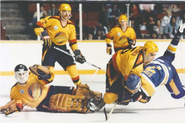  ?? STEVE BOSCH/PNG FILES ?? Canucks goalie Richard Brodeur is down in this 1985-86 game against Los Angeles, while Garth Butcher tangles with the Kings’ Phil Sykes and Doug Hallward looks on. The Canucks made the playoffs despite a 23-44-13 record, but were swept by Edmonton in the first round.