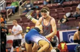  ??  ?? Dan Mancini of Owen J. Roberts lifts Nazareth’s Nathan Stefanik during an 8-2 decision at 145 pounds on Thursday night at the PIAA Team Wrestling Championsh­ips.