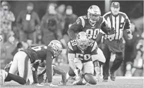  ?? GREG M. COOPER, USA TODAY SPORTS ?? Patriots linebacker Rob Ninkovich recovers a third-quarter fumble Sunday.