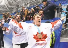  ?? Harry How / Getty Images ?? Canada’s Ben Scrivens leads the celebratio­n after his team won the bronze medal by beating the Czech Republic 6-4.