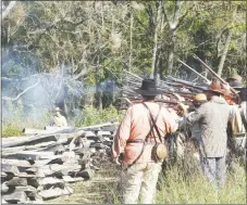  ?? TIMES photograph by Annette Beard ?? Civil War reenactors fired shots in salute when a wreath was placed on the Pea Ridge National Military Park Friday morning in honor of the Texas soldiers who fought and died in the Battle of Pea Ridge in March 1862.