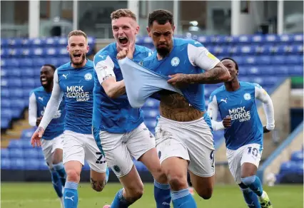  ?? Picture: Bradley Collyer/PA ?? Jonson Clarke-Harris, right, celebrates scoring the goal against Lincoln which secured promotion for Peterborou­gh United to the Championsh­ip