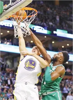  ?? — AFP photo ?? Jaylen Brown (R) of the Boston Celtics blocks a shot from Klay Thompson of the Golden State Warriors during the second quarter at TD Garden on November 16, 2017 in Boston, Massachuse­tts.